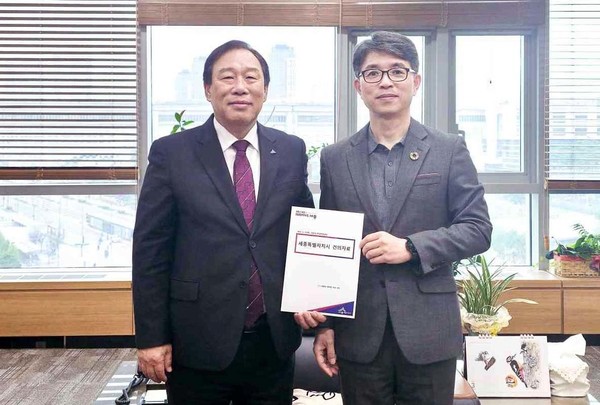 27일 정부세종청사에서 열린 회의에서 최민호 세종시장(왼쪽)은 김완섭 환경부 장관에게 세종보 재가동을 요청하는 건의서를 전달했다. 출처=세종시 