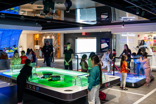 LG전자 북미법인 본사 인근 학생들이 사옥 내 과학관 'LG Inspiration Lab'을 방문하고 올레드 수족관, 로봇 청소기 축구 게임 등 LG전자의 제품을 활용한 다양한 체험을 진행하며 과학에 대한 흥미를 키울 수 있는 교육 프로그램을 체험하고 있다. 사진=LG전자