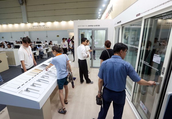 코리아빌드 위크에서 관람객들이 LX Z:IN 창호 뷰프레임을 보고 있는 모습 